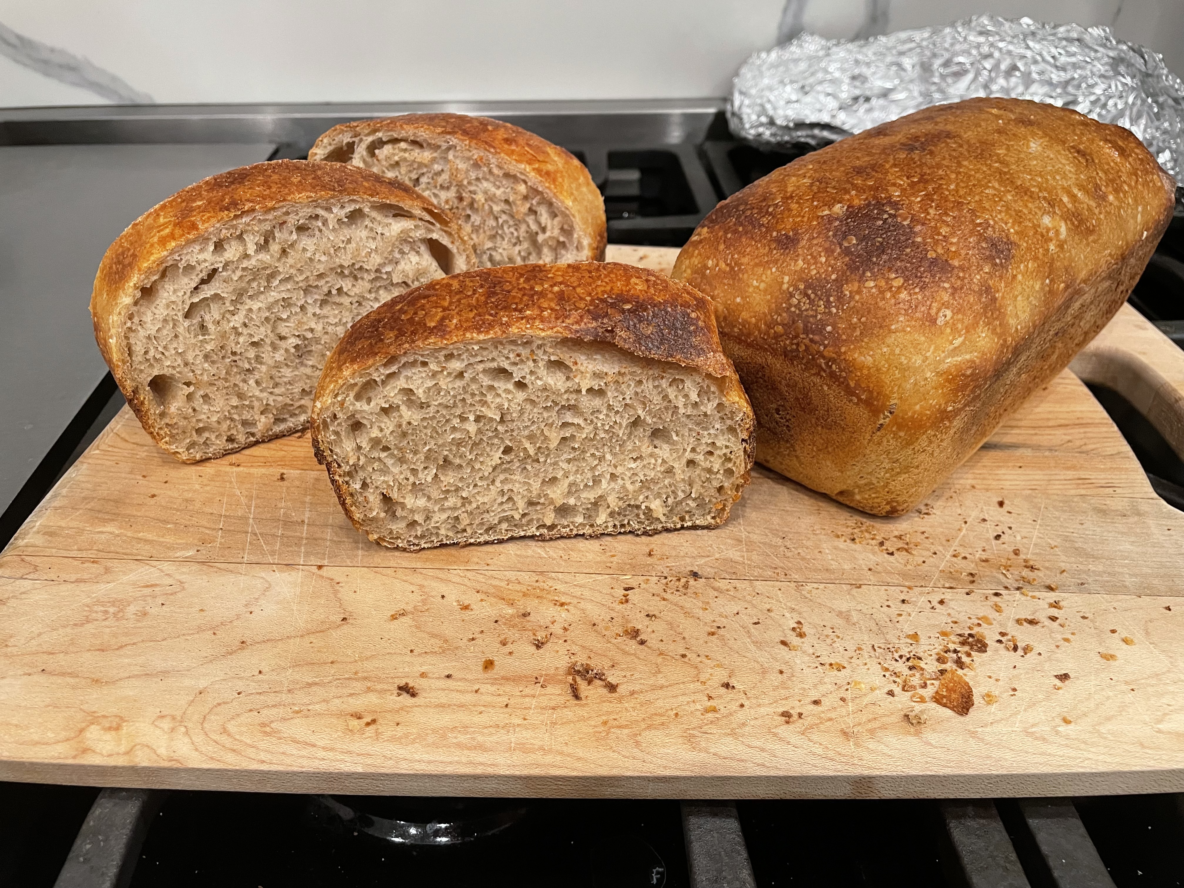 A whole sourdough loaf and a few slices from another